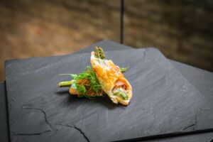 Asparagus with ham and cheese baked in puff pastry